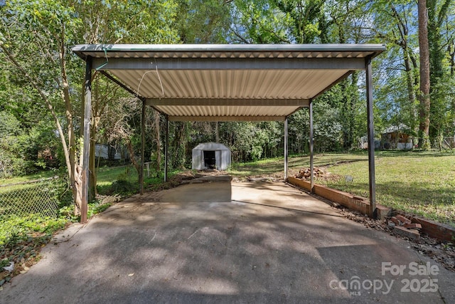 1801 Weststone Dr, Charlotte, NC 28208 - view of patio / terrace with a carport, a storage shed, fence, an outdoor structure, and driveway