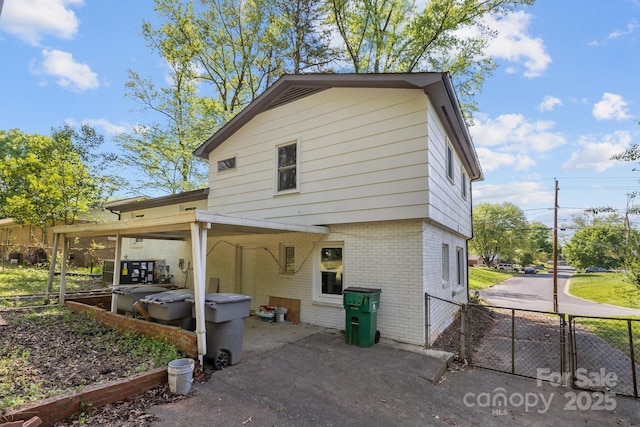 1801 Weststone Dr, Charlotte, NC 28208 - rear view of property with a patio, a carport, a gate, brick siding, and fence