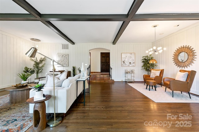 living room with visible vents, arched walkways, beamed ceiling, wood finished floors, and stairs