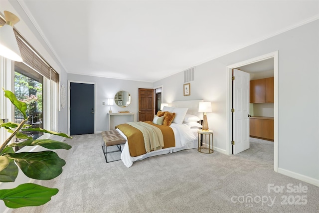 carpeted bedroom featuring crown molding, baseboards, and visible vents