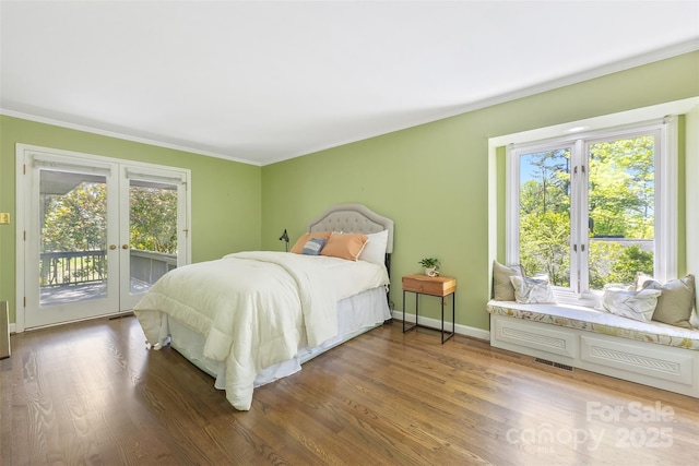 bedroom with access to outside, multiple windows, and crown molding