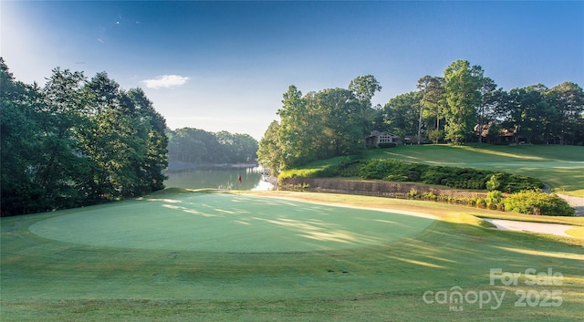 view of home's community with a water view and golf course view