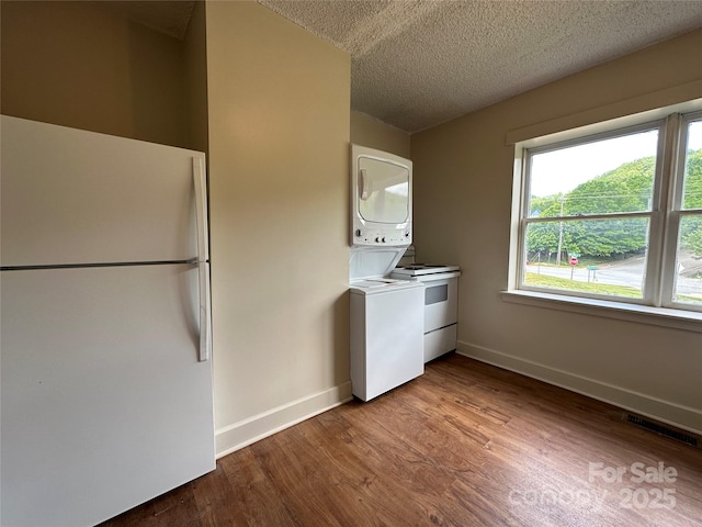 31 Hildebrand St Unit 1 & 154, Asheville, NC 28801 - kitchen with freestanding refrigerator, wood finished floors, visible vents, and stacked washer / drying machine