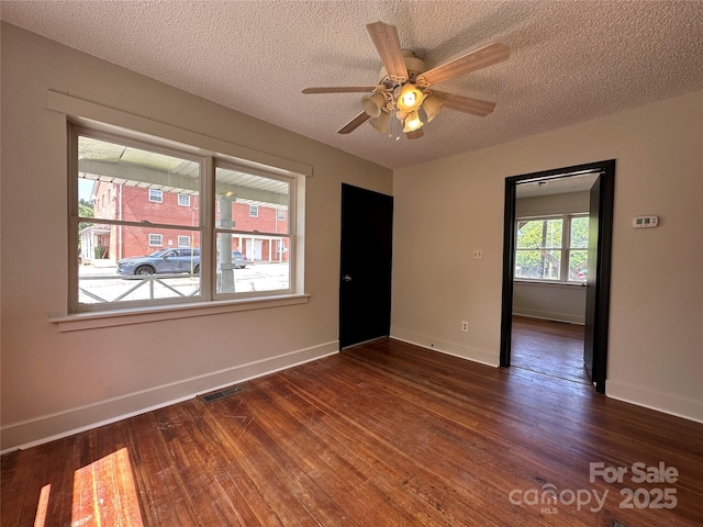 31 Hildebrand St Unit 1 & 154, Asheville, NC 28801 - spare room with a ceiling fan, a textured ceiling, dark wood finished floors, baseboards, and visible vents