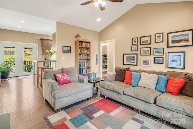 living room featuring vaulted ceiling, recessed lighting, french doors, a ceiling fan, and wood finished floors