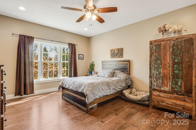 bedroom featuring baseboards, ceiling fan, wood finished floors, and recessed lighting