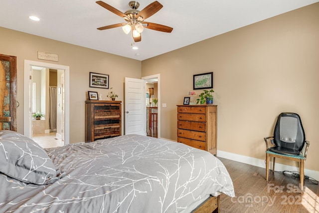 bedroom featuring a ceiling fan, wood finished floors, ensuite bathroom, baseboards, and recessed lighting