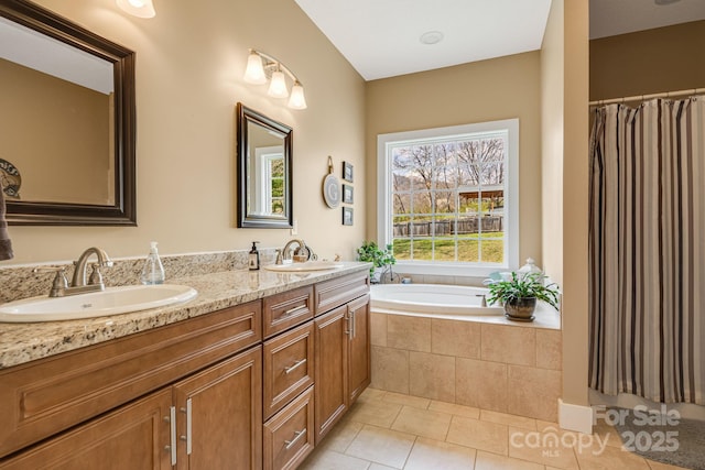 bathroom featuring a garden tub, double vanity, a sink, and tile patterned floors