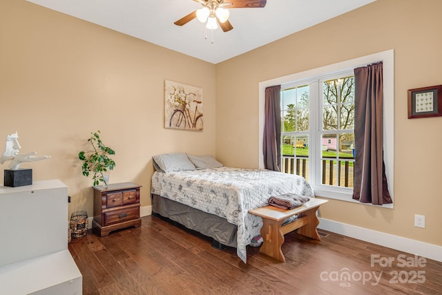 bedroom featuring baseboards, ceiling fan, and wood finished floors