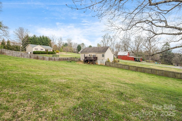 view of yard featuring an outbuilding and fence private yard