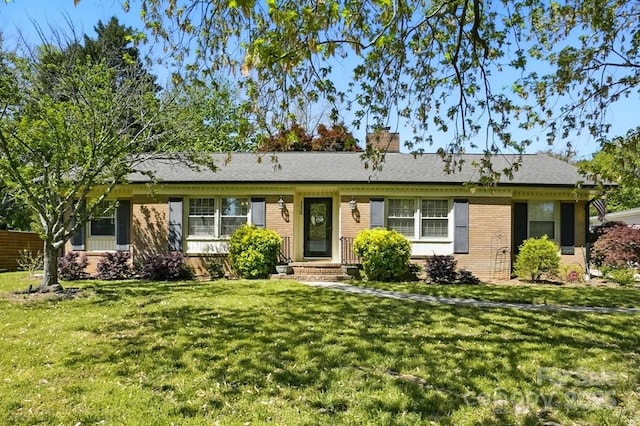 110 Tanglewood Dr, Kannapolis, NC 28081 - ranch-style house featuring brick siding, a front lawn, and a chimney