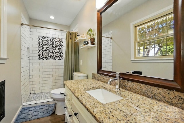 110 Tanglewood Dr, Kannapolis, NC 28081 - full bathroom with vanity, a fireplace, toilet, tiled shower, and wood finished floors
