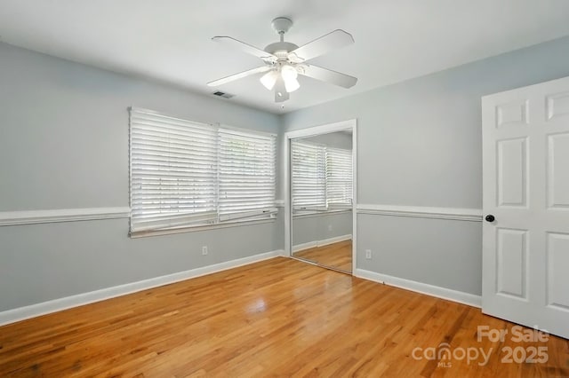 110 Tanglewood Dr, Kannapolis, NC 28081 - unfurnished bedroom featuring a closet, baseboards, a ceiling fan, visible vents, and wood finished floors