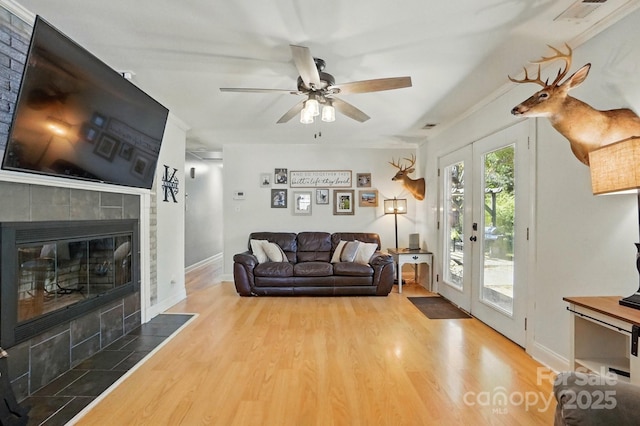 110 Tanglewood Dr, Kannapolis, NC 28081 - living room featuring wood finished floors, ceiling fan, a tiled fireplace, and visible vents