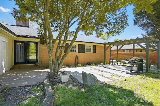 110 Tanglewood Dr, Kannapolis, NC 28081 - back of house featuring a pergola, a patio area, fence, brick siding, and a chimney
