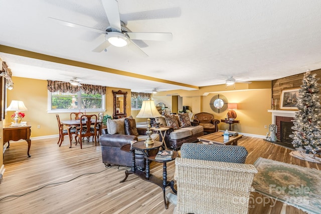 142 Country Club Dr, Waynesville, NC 28786 - living area with a fireplace, light wood-style floors, a ceiling fan, and baseboards