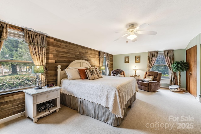 142 Country Club Dr, Waynesville, NC 28786 - carpeted bedroom featuring ceiling fan and wood walls