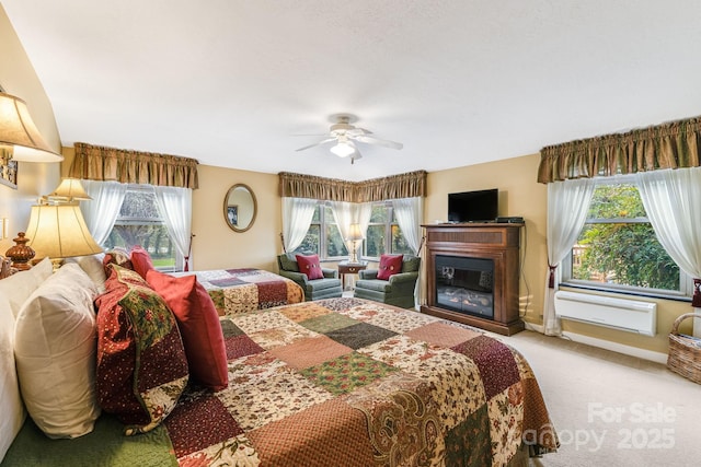 142 Country Club Dr, Waynesville, NC 28786 - bedroom with baseboards, a ceiling fan, a glass covered fireplace, and carpet