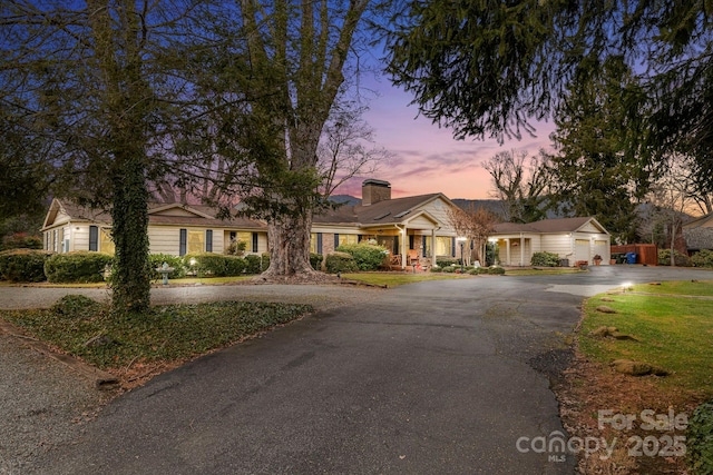 142 Country Club Dr, Waynesville, NC 28786 - ranch-style house with a chimney, an attached garage, and aphalt driveway