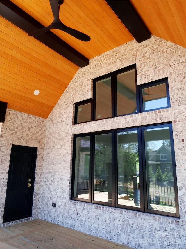 entrance to property featuring brick siding