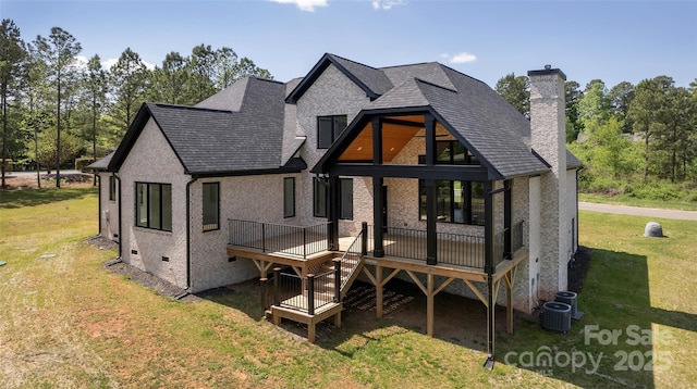 rear view of property featuring a shingled roof, crawl space, a lawn, a chimney, and a wooden deck