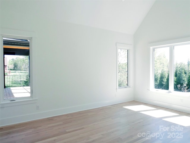 spare room featuring light wood-style flooring and plenty of natural light