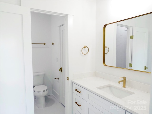 bathroom featuring toilet and vanity