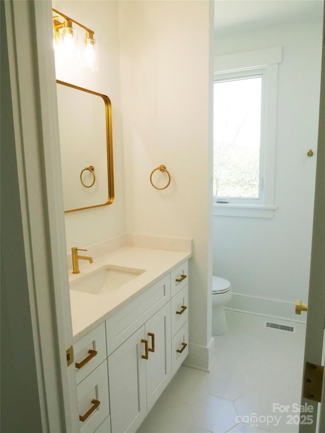 bathroom with vanity, tile patterned flooring, visible vents, toilet, and baseboards