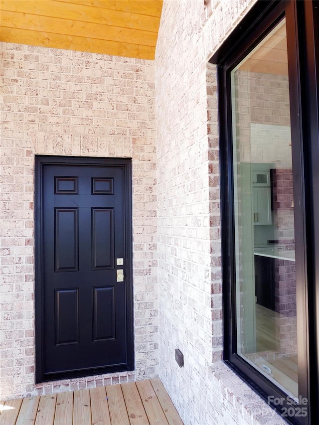 property entrance with brick siding