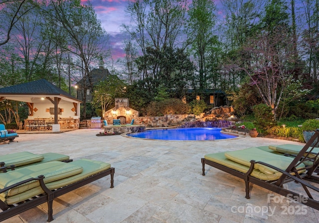 200 Highland Forest Dr, Charlotte, NC 28270 - pool at dusk with an outdoor stone fireplace, a patio area, an outdoor pool, and a gazebo