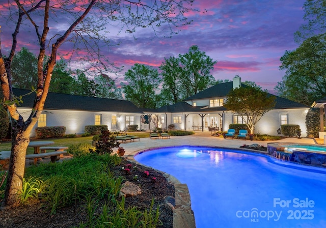 200 Highland Forest Dr, Charlotte, NC 28270 - pool at dusk featuring a patio and a pool with connected hot tub