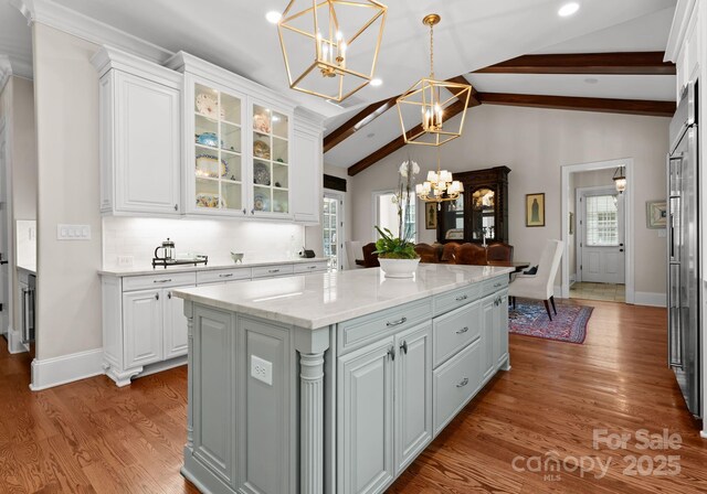 200 Highland Forest Dr, Charlotte, NC 28270 - kitchen featuring a chandelier, white cabinets, wood finished floors, pendant lighting, and a kitchen island