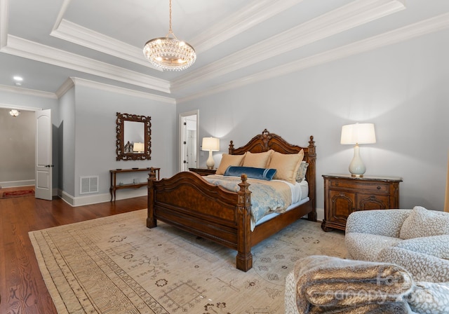 200 Highland Forest Dr, Charlotte, NC 28270 - bedroom with a chandelier, crown molding, wood finished floors, a raised ceiling, and baseboards