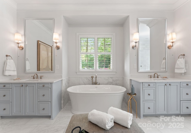 200 Highland Forest Dr, Charlotte, NC 28270 - bathroom with two vanities, a freestanding tub, marble finish floors, and ornamental molding