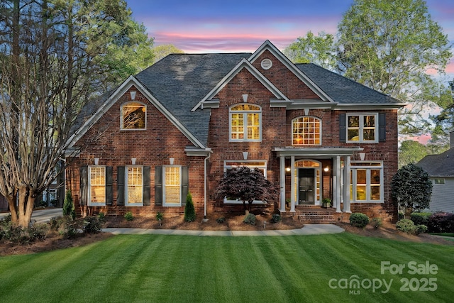 view of front of property with brick siding and a front yard