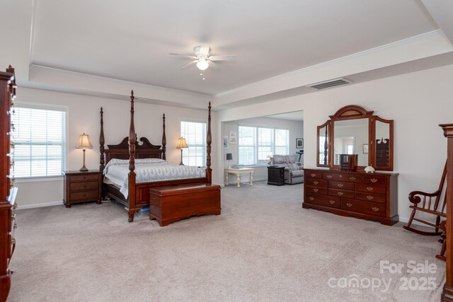 2097 Saddlebred Dr, Iron Station, NC 28080 - carpeted bedroom featuring ornamental molding, a tray ceiling, and visible vents