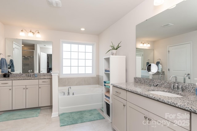 2097 Saddlebred Dr, Iron Station, NC 28080 - full bath with a sink, tile patterned floors, a garden tub, and two vanities