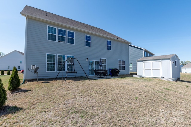 2097 Saddlebred Dr, Iron Station, NC 28080 - back of house featuring a yard, a patio, an outdoor structure, and a storage unit