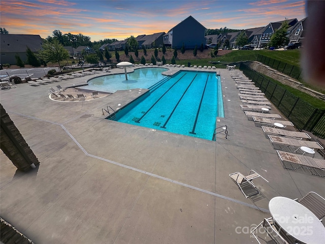 2097 Saddlebred Dr, Iron Station, NC 28080 - pool at dusk with fence, a community pool, and a patio area