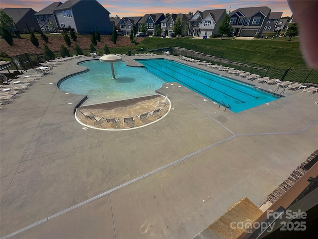 2097 Saddlebred Dr, Iron Station, NC 28080 - pool at dusk with a residential view, a community pool, and a patio area