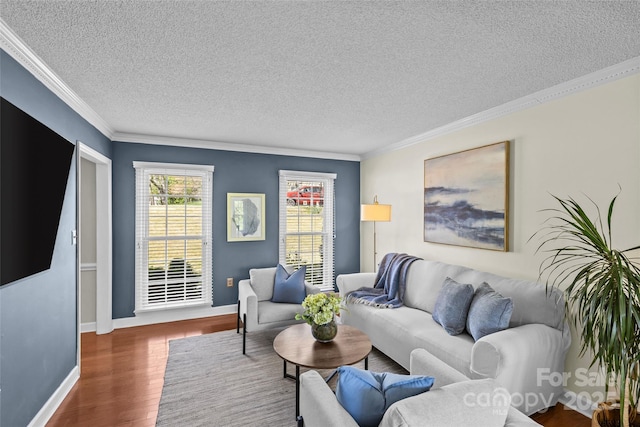 living room with baseboards, wood finished floors, ornamental molding, and a textured ceiling