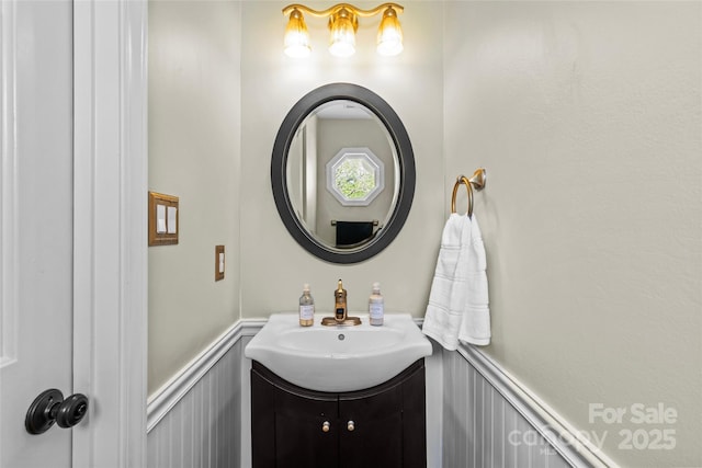 bathroom with wainscoting and vanity