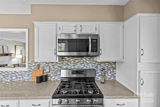 kitchen with white cabinetry, light countertops, and stainless steel appliances