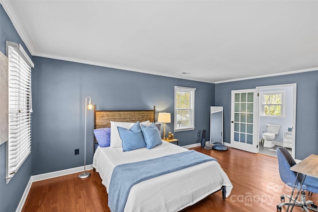 bedroom featuring crown molding, baseboards, and wood finished floors