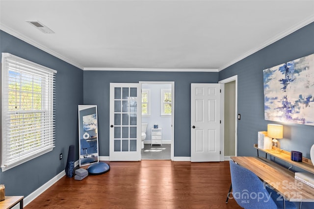 home office featuring baseboards, visible vents, wood finished floors, and a healthy amount of sunlight