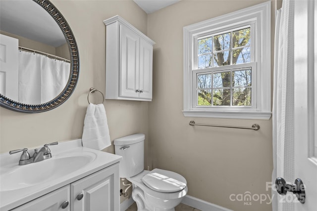 full bath with baseboards, toilet, and vanity