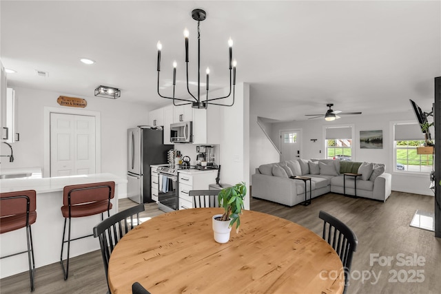 dining room featuring visible vents, recessed lighting, ceiling fan with notable chandelier, and light wood finished floors