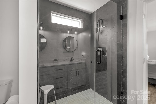 full bath featuring a shower stall, toilet, and vanity