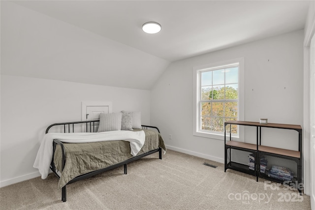 bedroom featuring carpet flooring, baseboards, lofted ceiling, and visible vents
