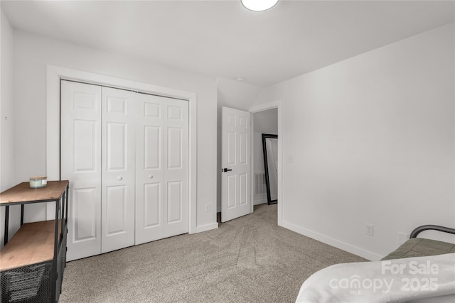 bedroom featuring baseboards, a closet, and carpet floors
